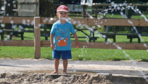 Young boy enjoying splash time at Farmer Palmer's Farm Park