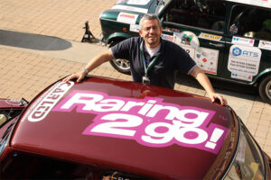 Freddie pictured next to a mini on the Italian Job event proudly displaying the old Raring2go! logo