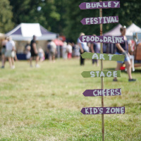 Signage for kids activities, food, drinks and stage at Burley family friendly Festival