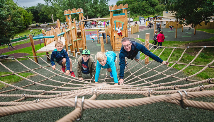 Children and parents on a play area at Baggeridge Country Park