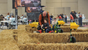 child on toy tractor
