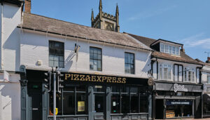 PizzaExpress East Grinstead shop front, with classic gold and back logo