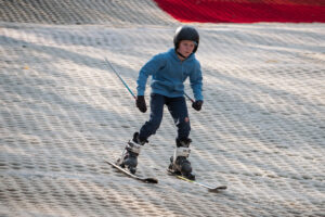 children learning to ski at the skiing adventure half term holiday camps at the oakwood esher