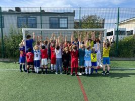 Ace Coaching Primary school sports coaching - picture of children cheering by a football goal