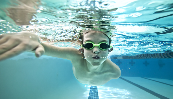 Boy swimming under water