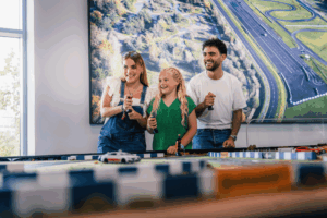 A family at Mercedes Benz World in Weybridge, Surrey enjoying the interactive attraction Family Fastrax